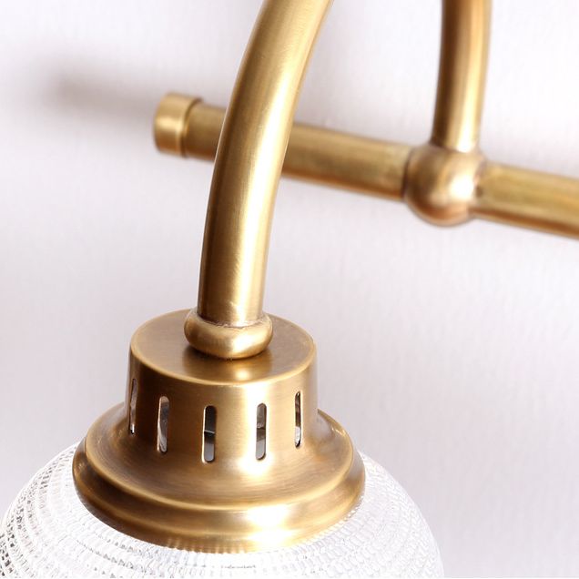 Antique brass prismatic glass vanity light