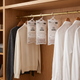 Hanging moisture absorbers in an oak wardrobe between knitwear and shirts
