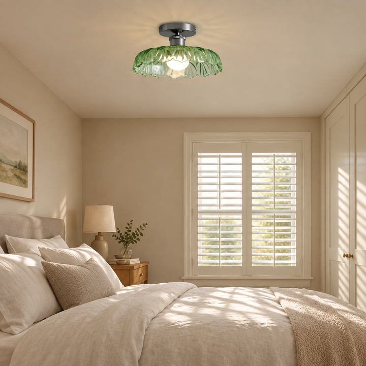 Green glass ceiling light in a calm bedroom