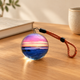 Digital memory sphere photo display on an oak desk