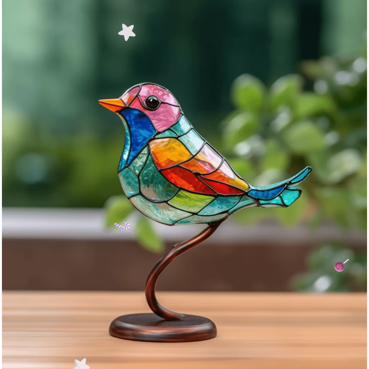 Stained glass bird ornament on bronze stand